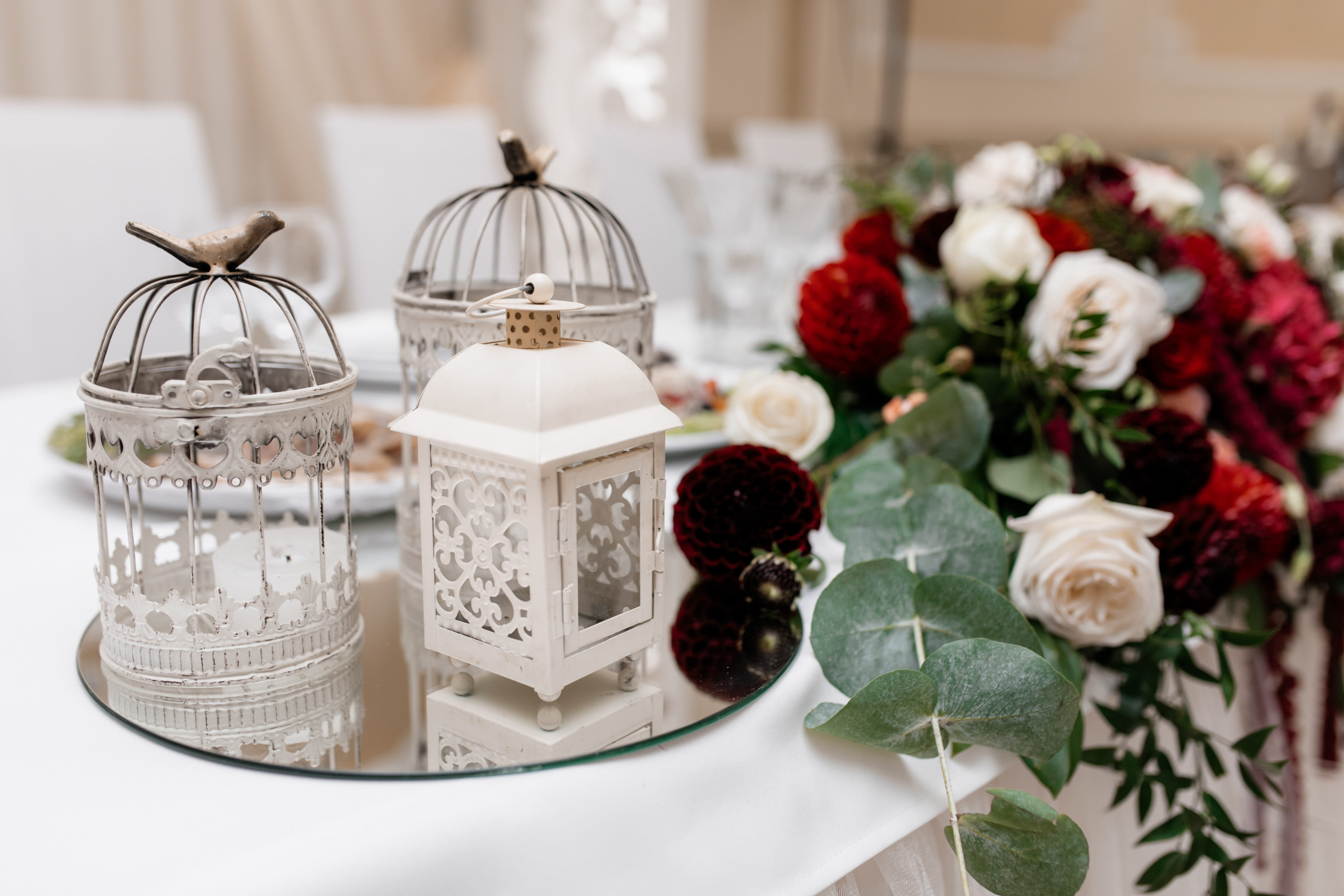 Floral wedding table arrangement with eucalyptus and roses